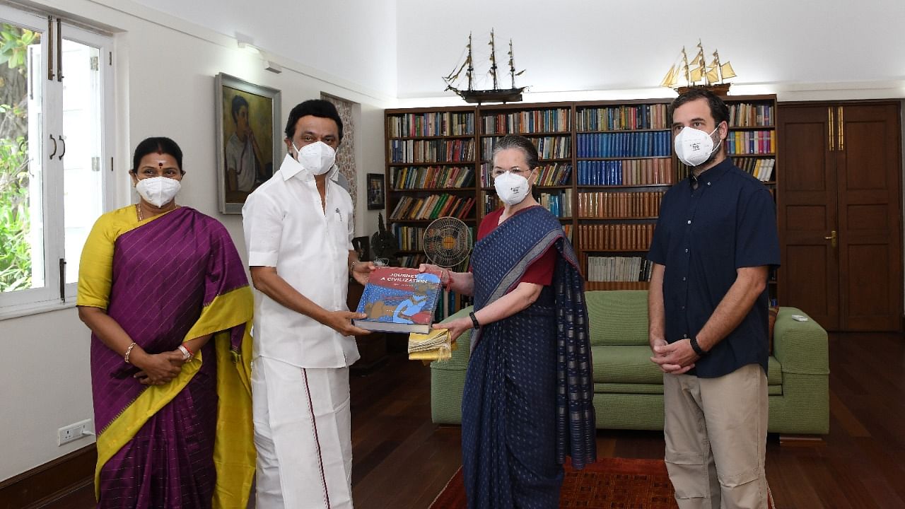 Tamil Nadu CM Stalin (2nd L) presents a copy of "Journey of a Civilisation - Indus to Vaigai" by R Balakrishnan, a retired civil servant, and a shawl to Sonia Gandhi (3rd L) during the meeting. Credit: Special Arrangement