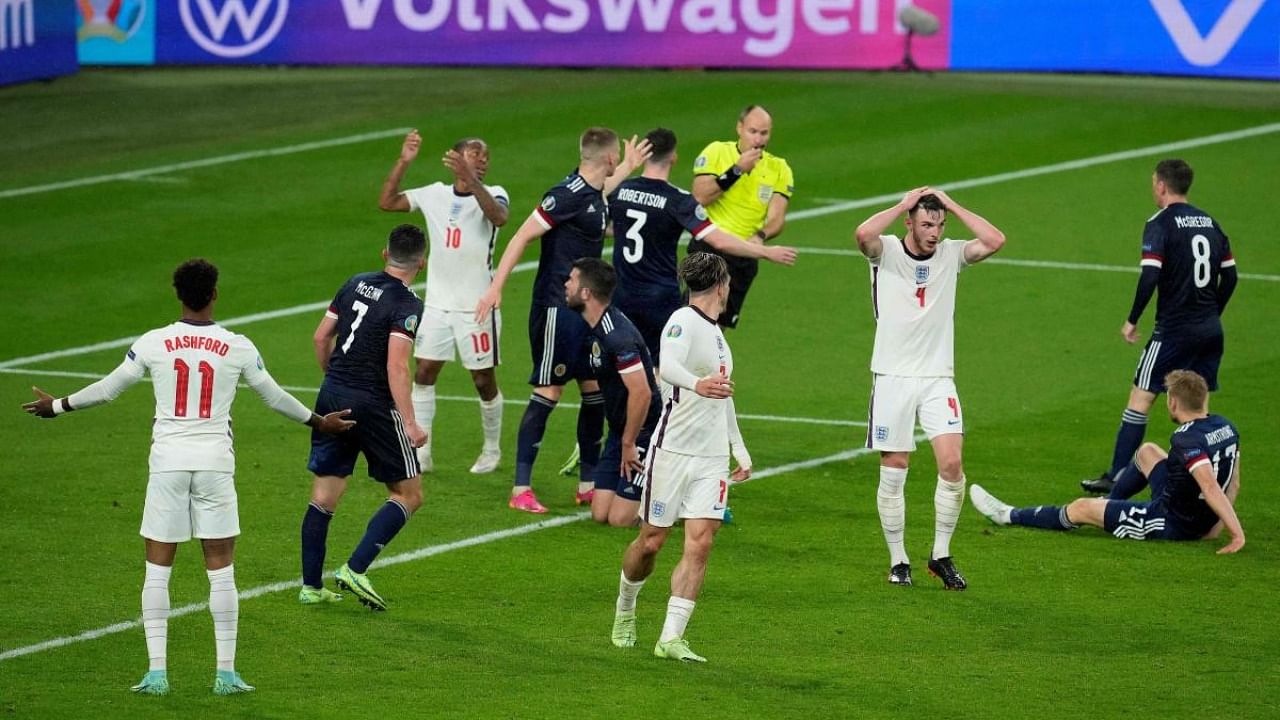 Players react during the UEFA EURO 2020 Group D football match between England and Scotland at Wembley Stadium in London. Credit: AFP Photo