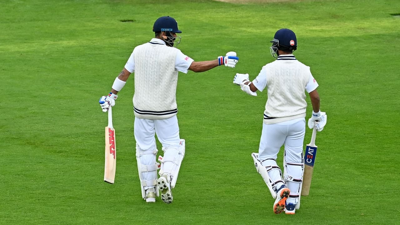 Virat Kohli (L) and Ajinkya Rahane walk to the wicket at the start of play on the Day 3 of the ICC World Test Championship Final between New Zealand and India in Southampton. Credit: AFP Photo