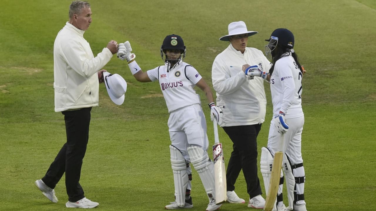 India's Taniya Bhatia and Sneh Rana shakes hands with the umpires after the match. Credit: Reuters Photo