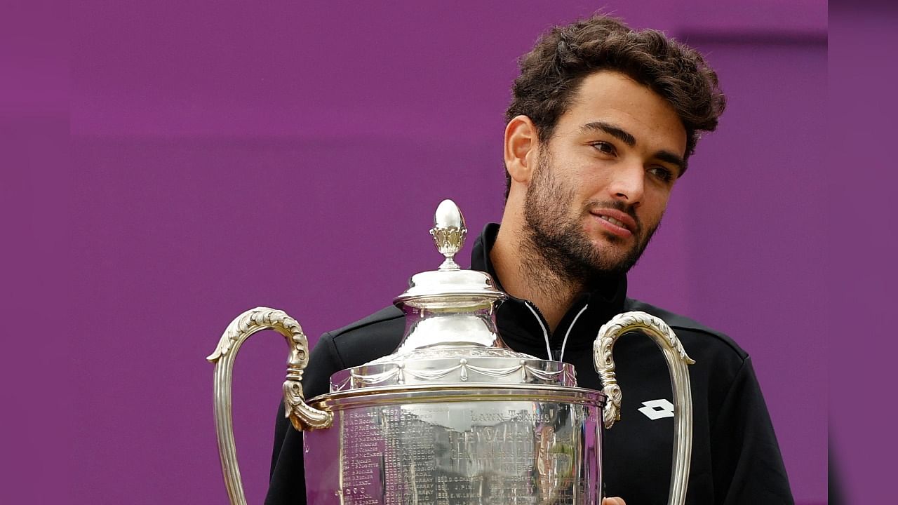 Italy's Matteo Berrettini poses with the winners trophy after his victory over Britain's Cameron Norrie at Queen's Club, London. Credit: AFP Photo