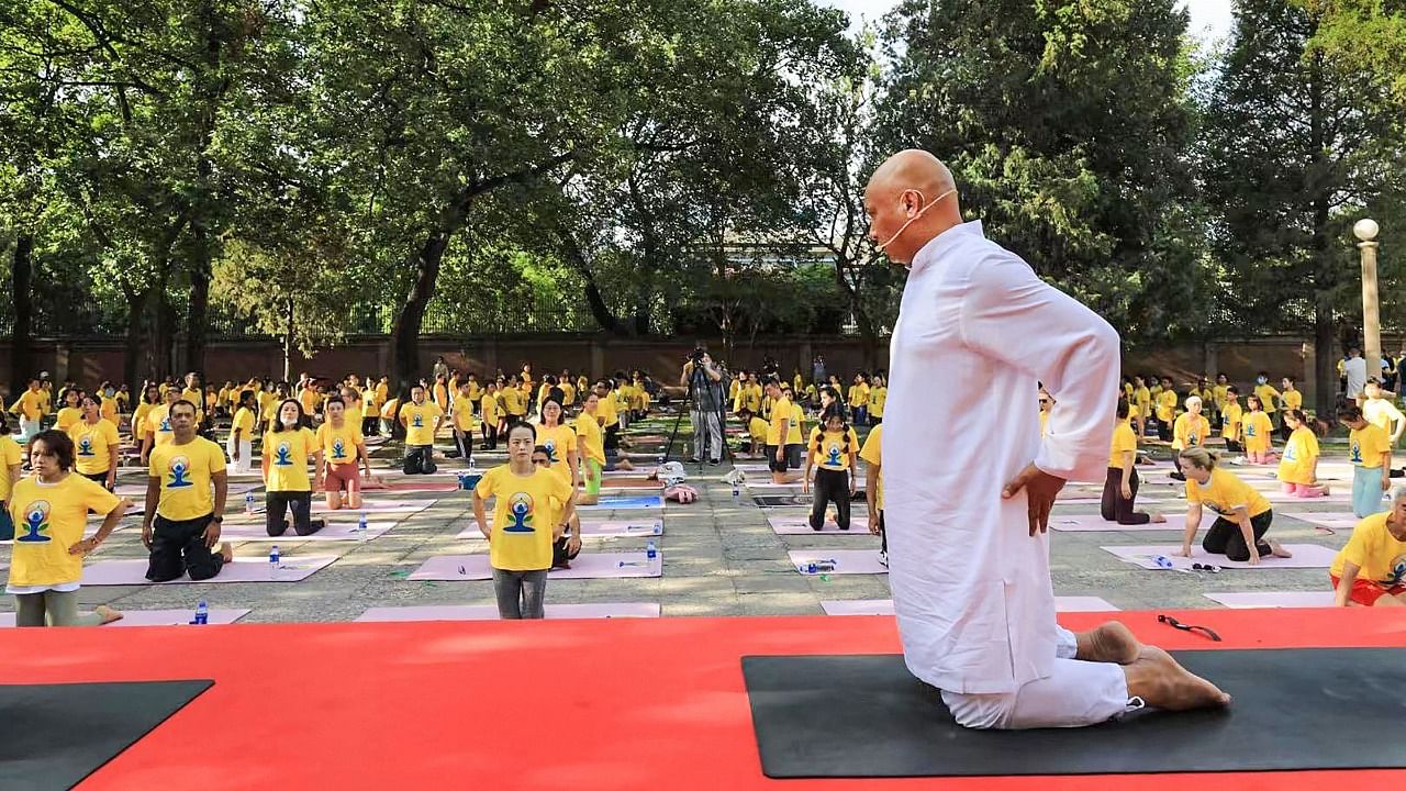 Chinese yoga enthusiasts take part in a yoga event at the Indian Embassy ahead of the International Yoga Day, in Beijing, Sunday, June 20, 2021. Credit: PTI Photo