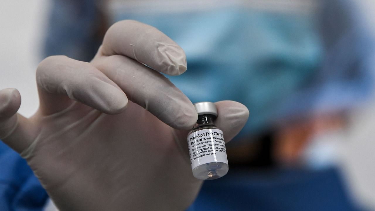 A nurse holds a vial of the Pfizer-BioNTech vaccine. Credit: AFP Photo