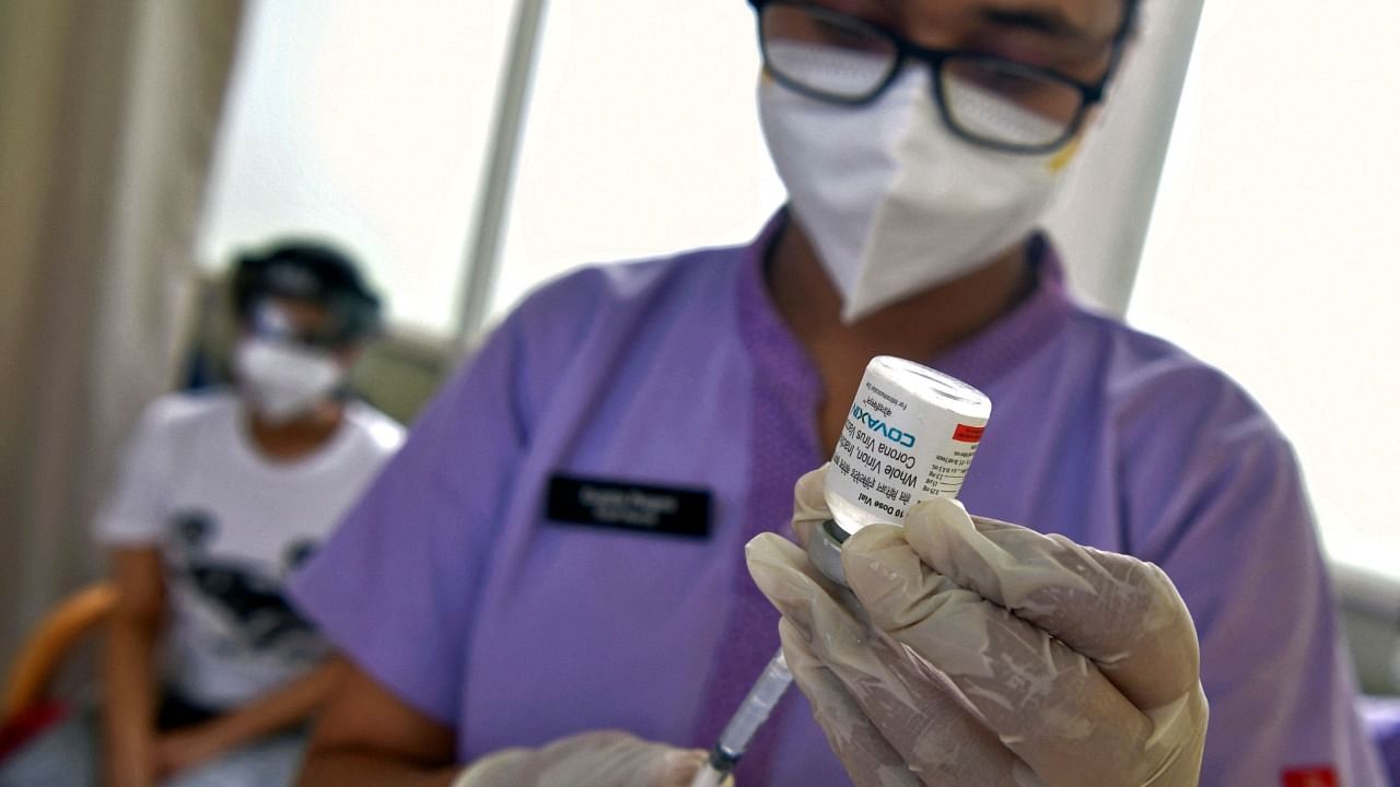 A nurse prepares to inculate a man with a dose of the Covaxin vaccine against the Covid-19 coronavirus at a vaccination centre in Manipal Hospital in Bangalore on June 18, 2021. Credit: AFP Photo