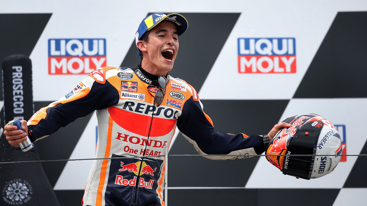 Honda Racing's Marc Marquez celebrates on the podium after winning the German MotoGP. Credit: AFP Photo