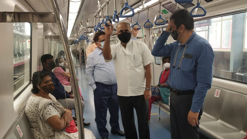 BMRCL Managing Director Rakesh Singh along with senior officials interact with passengers in a train on Monday. Credit: DH photo