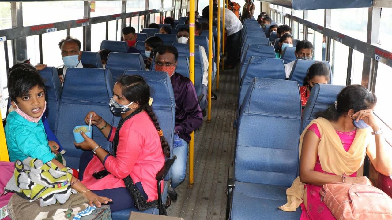  Passengers follow guidelines while sitting in a KSRTC bus at the new bus stand in Hassan on Monday. Credit: DH Photo