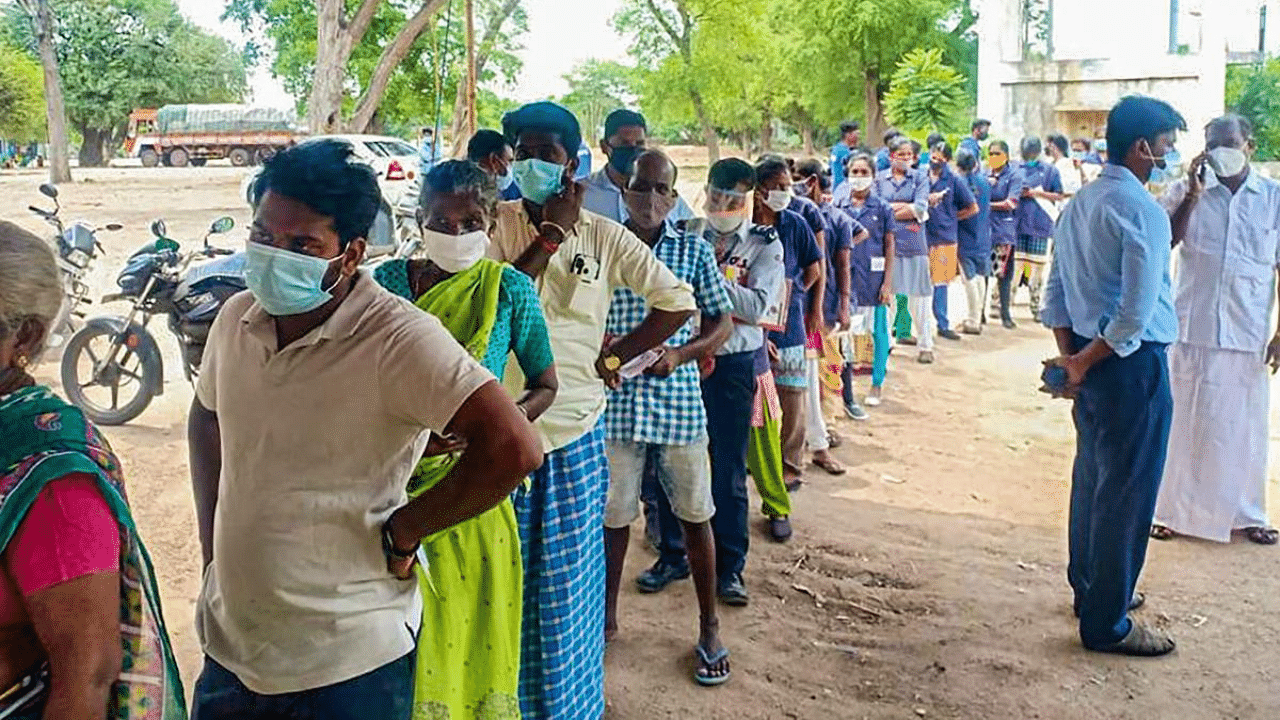 Beneficiaries wait in a queue to receive Covid-19 vaccine dose, at a primary health centre in Puducherry. Credit: PTI Photo