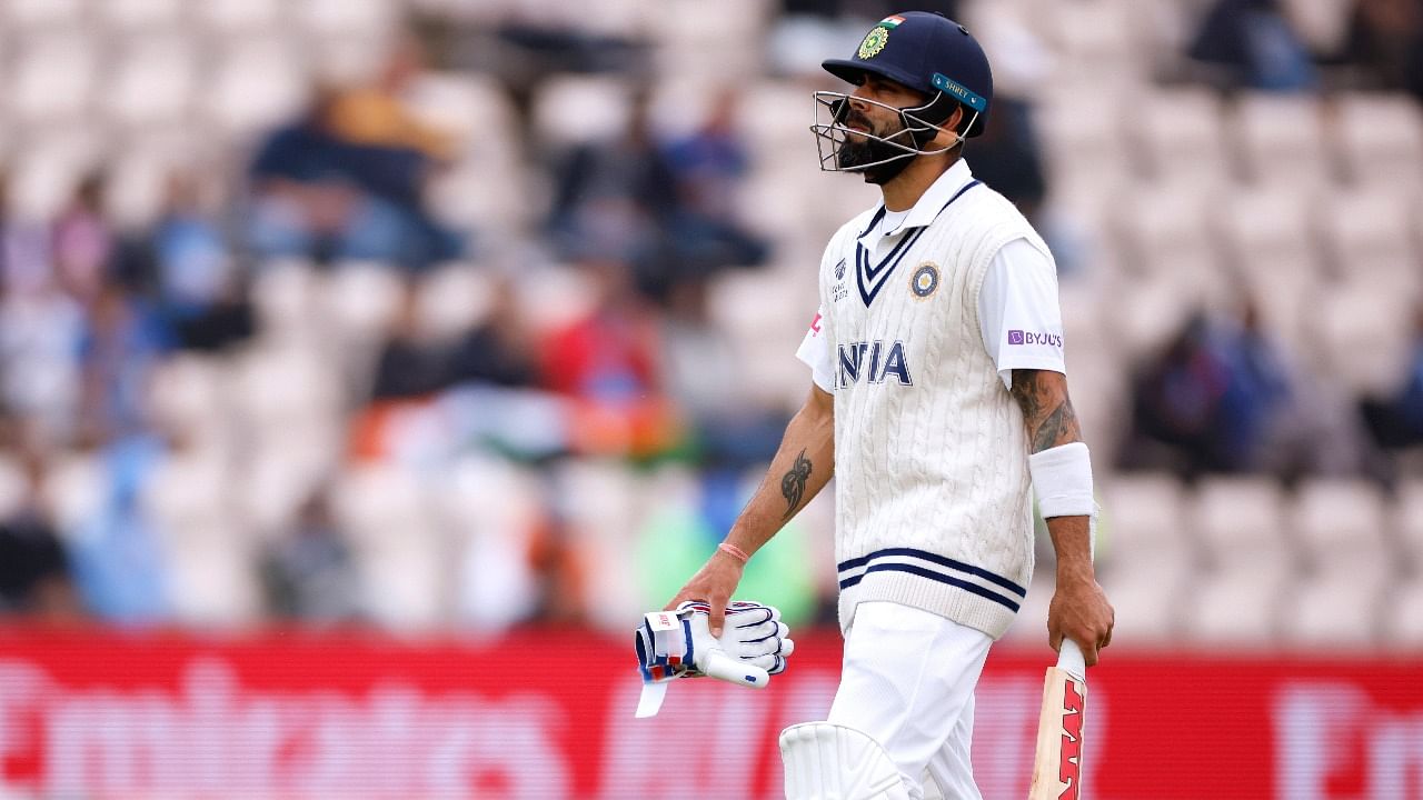 Virat Kohli looks dejected as he walks off after losing his wicket for LBW off the bowling of New Zealand's Kyle Jamieson. Credit: Reuters photo