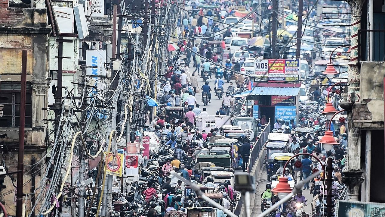 Commuters on their vehicles stand in a traffic jam after the government eased restrictions imposed as a preventive measure against the Covid-19 coronavirus, in Allahabad on June 21, 2021. Credit: AFP Photo
