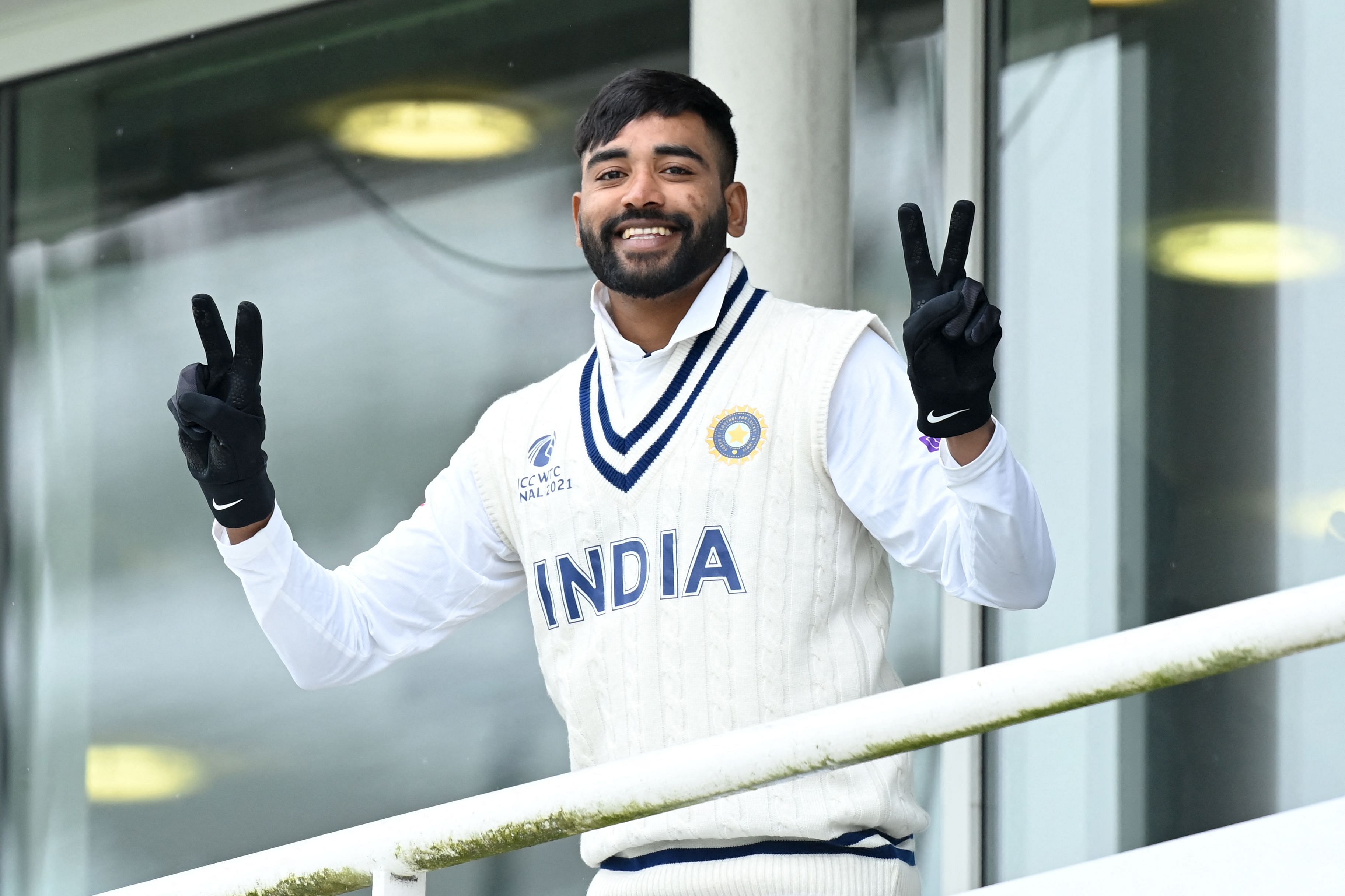 India's Mohammed Siraj gestures on the dressing room balcony prior to start of play on the fifth day of the ICC World Test Championship Final. Credit: AFP Photo