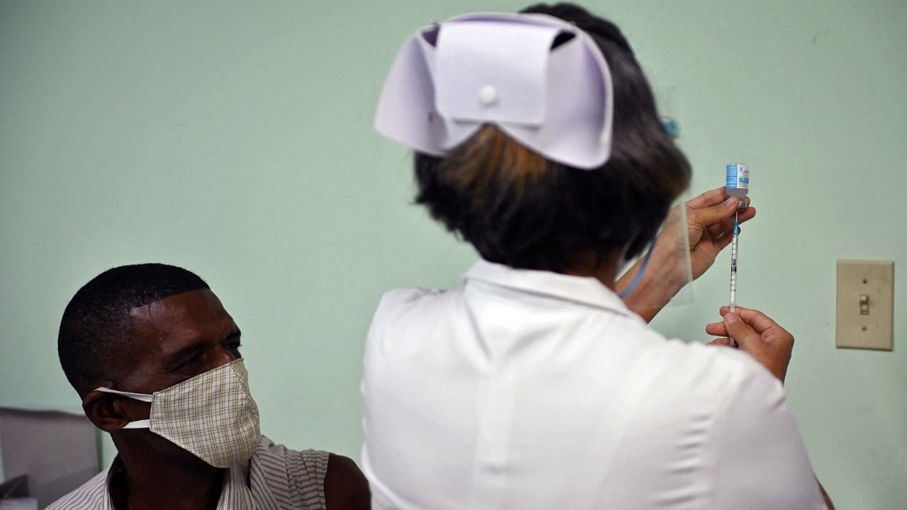 A nurse prepares to inoculate a health worker with the second dose of the Cuban Covid-19 vaccine candidate Abdala in Cienfuegos, Cuba. Credit: AFP Photo
