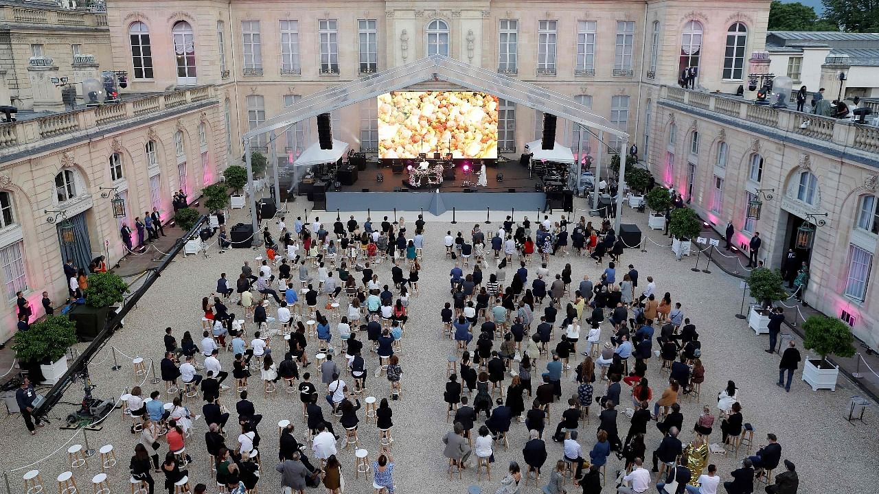 Audience members sit socially distanced in the courtyard of the Elysee Palace as they listen to electronic music performer Irene Dresel during France's annual 'fete de la musique' music festival in the courtyard of the presidential Elysee Palace in Paris. Credit: AFP Photo