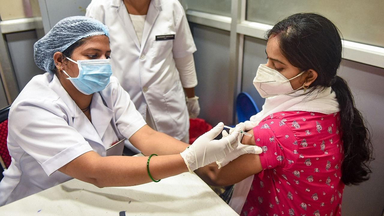 A medic administers a dose of Covid-19 vaccine to a woman, at Civil hospital in Lucknow. Credit: PTI File Photo