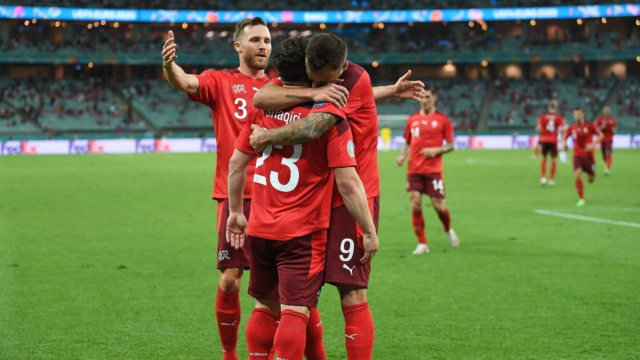 Switzerland's midfielder Xherdan Shaqiri (C) celebrates scoring his team's third goal with his teammates during the UEFA EURO 2020 Group A football match between Switzerland and Turkey. Credit: AFP Photo