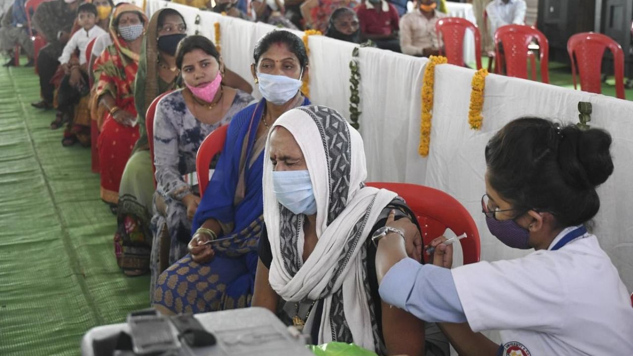 A health worker administers a Covid-19 vaccine during a vaccination drive in Bhopal. Credit: PTI Photo