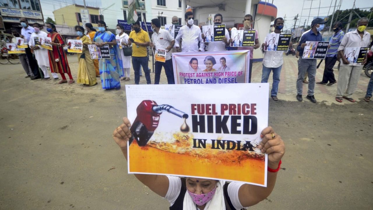Tripura Pradesh Congress members stage a protest against the price hike of petrol and diesel in front of fuel station, in Agartala. Credit: PTI photo