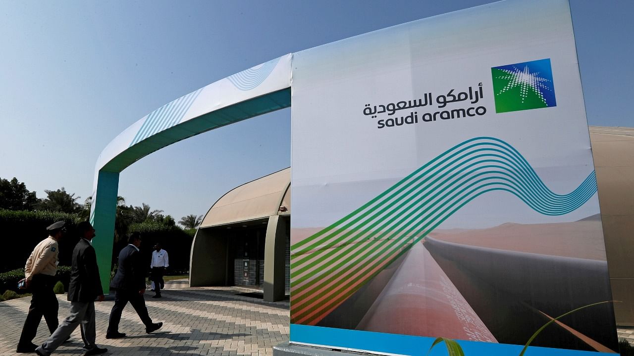 Logo of Aramco is seen as security personnel walk before the start of a press conference by Aramco at the Plaza Conference Center in Dhahran. Credit: Reuters File Photo