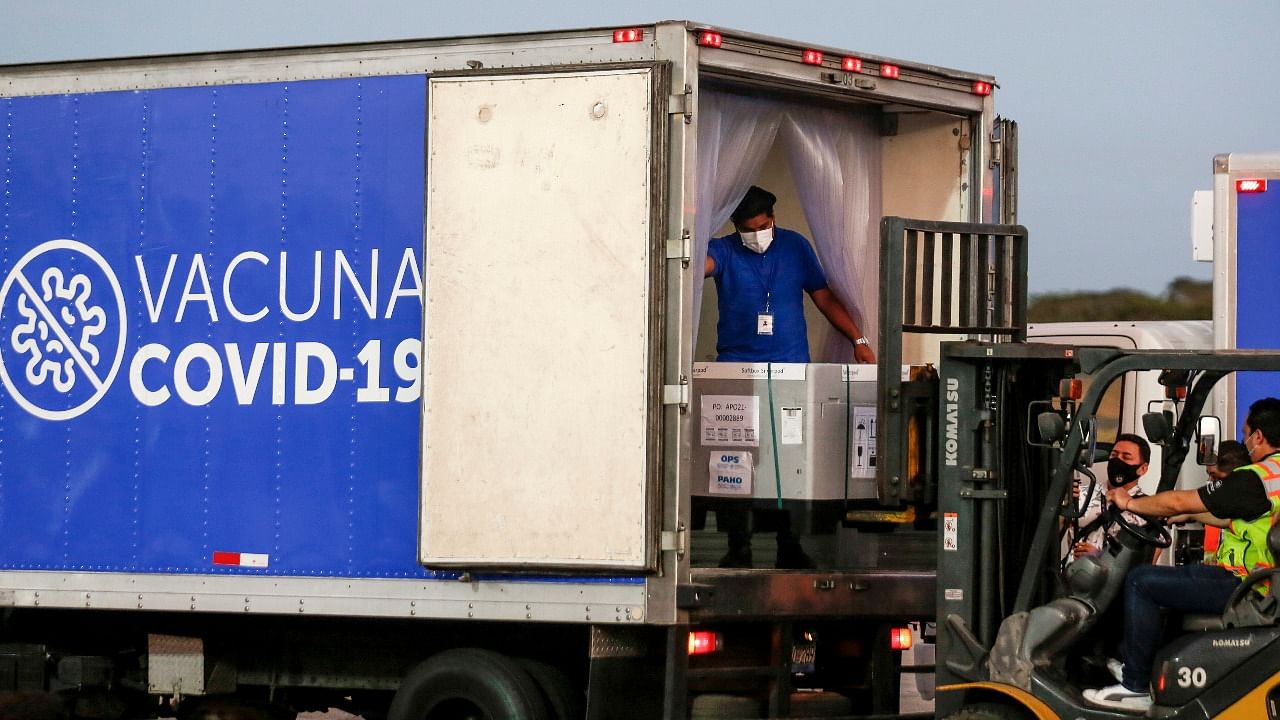 Containers of AstraZeneca (SKBio Corea) vaccines under the COVAX scheme are loaded onto a truck after arriving at the Mons. Oscar Arnulfo Romero International Airport, in San Luis Talpa, El Salvador. Credit: Reuters file photo
