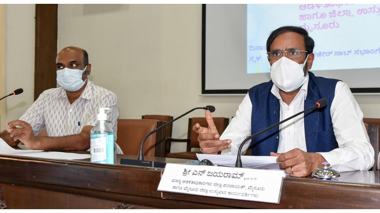 District in-Charge Secretary N Jayaram chairs a progress review meeting in Mysuru on Thursday. ZP CEO Yogeesh is seen. Credit: DH Photo