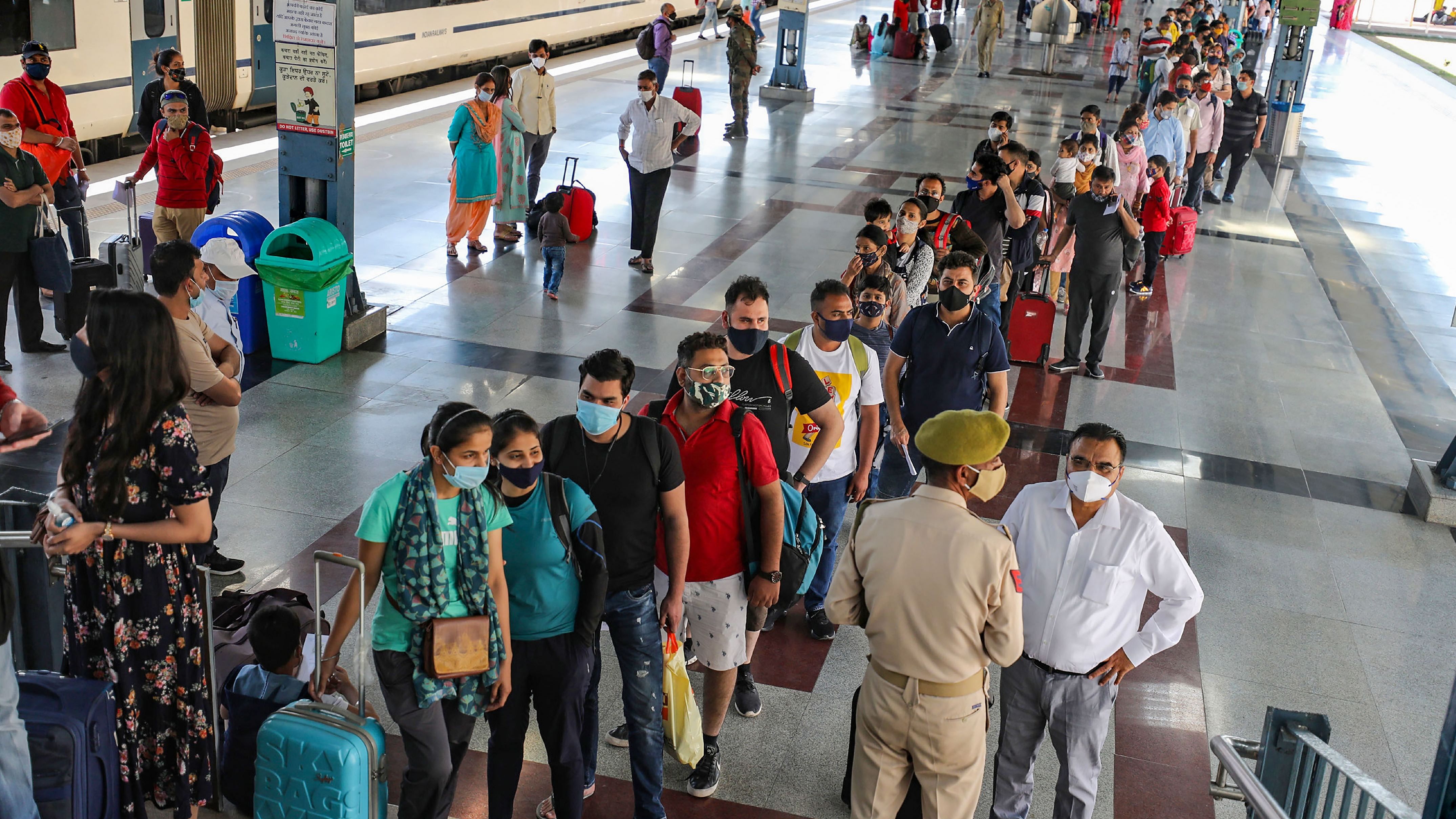 Pilgrims wait to be tested for COVID-19 after arriving in Katra to visit the Mata Vaishno Devi shrine. Credit: PTI Photo