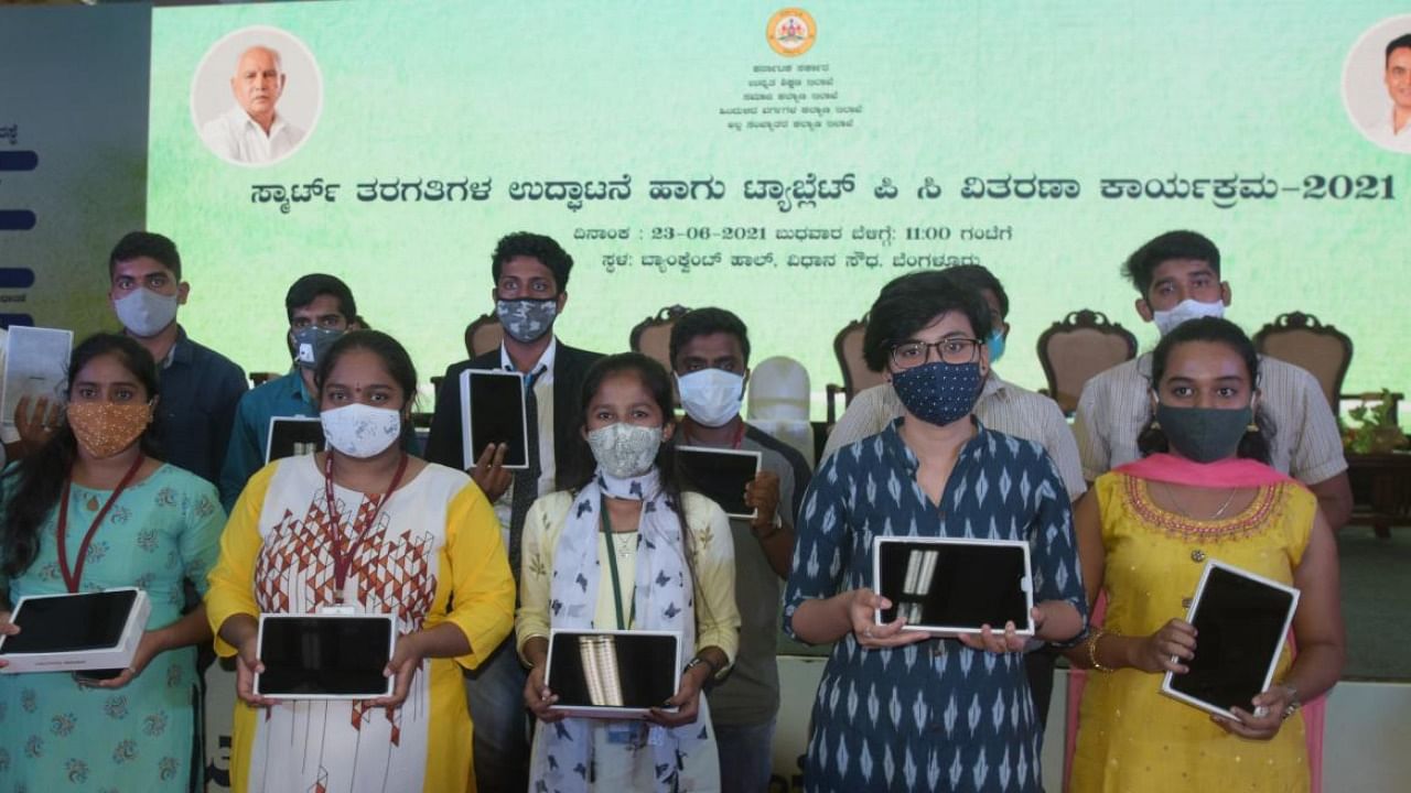 Students with the tablets for the smart classroom. Credit: DH Photo