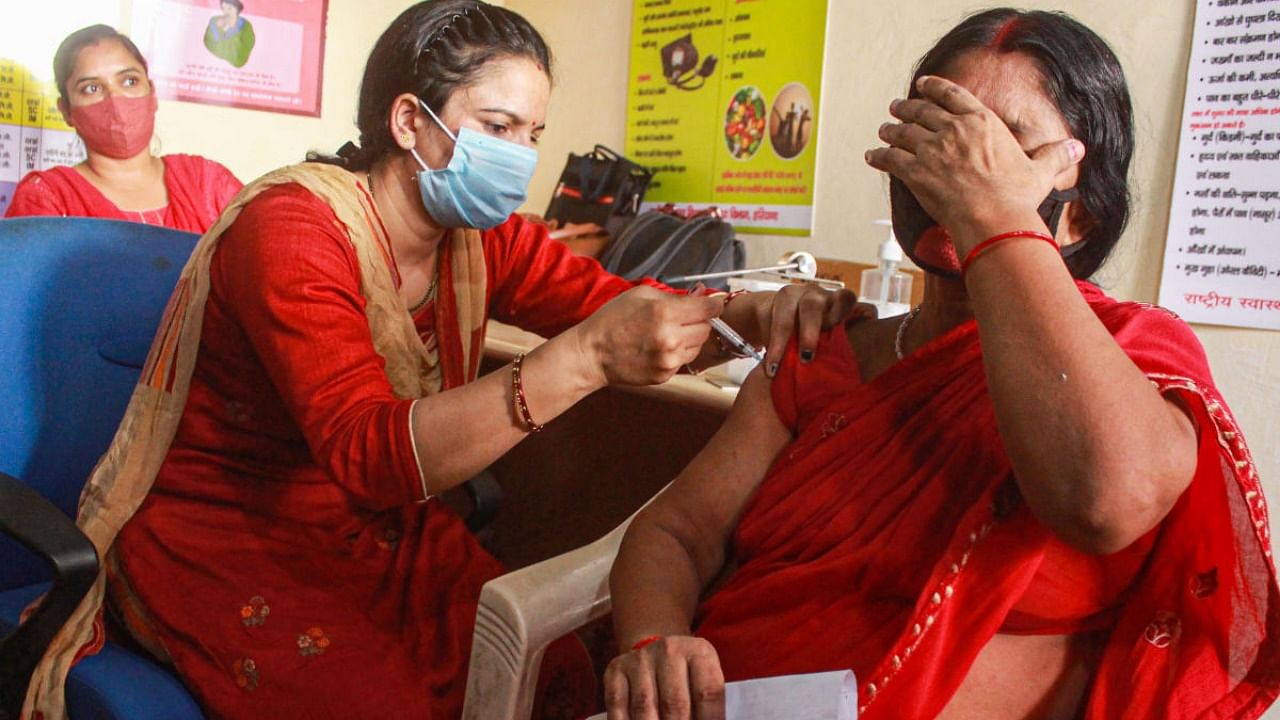 A health worker administers a dose of Covid-19 vaccine to beneficiary, in Gurugram. Credit: PTI photo
