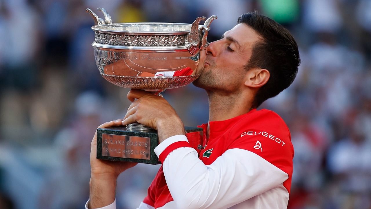 Djokovic celebrates with the trophy after winning the French Open. Credit: Reuters Photo