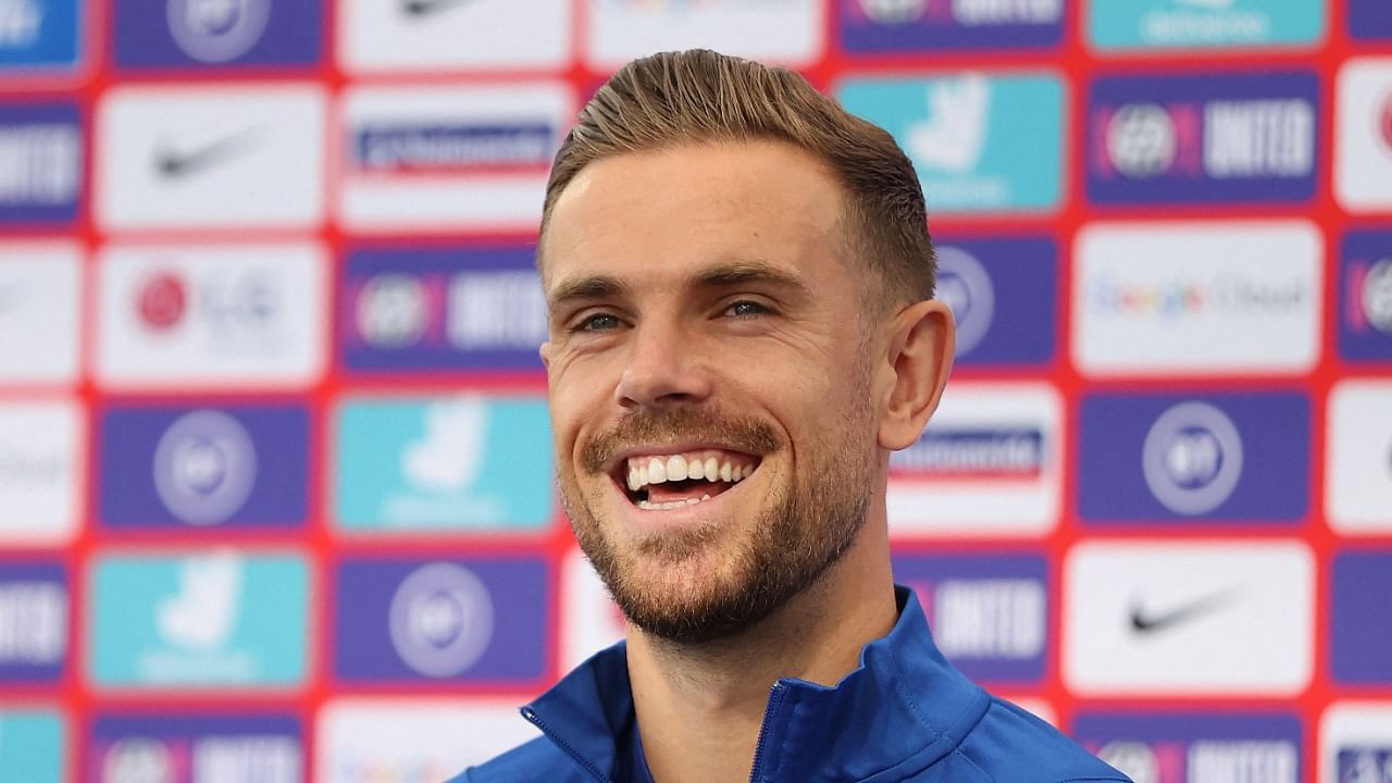 England's midfielder Jordan Henderson laughs during a press conference at St George's Park in Burton-on-Trent. Credit: AFP Photo