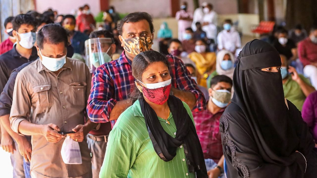 Beneficiaries wait to receive the Covid-19 vaccine at a vaccination camp, in Kozhikode, Wednesday, June 9, 2021. Credit: PTI Photo