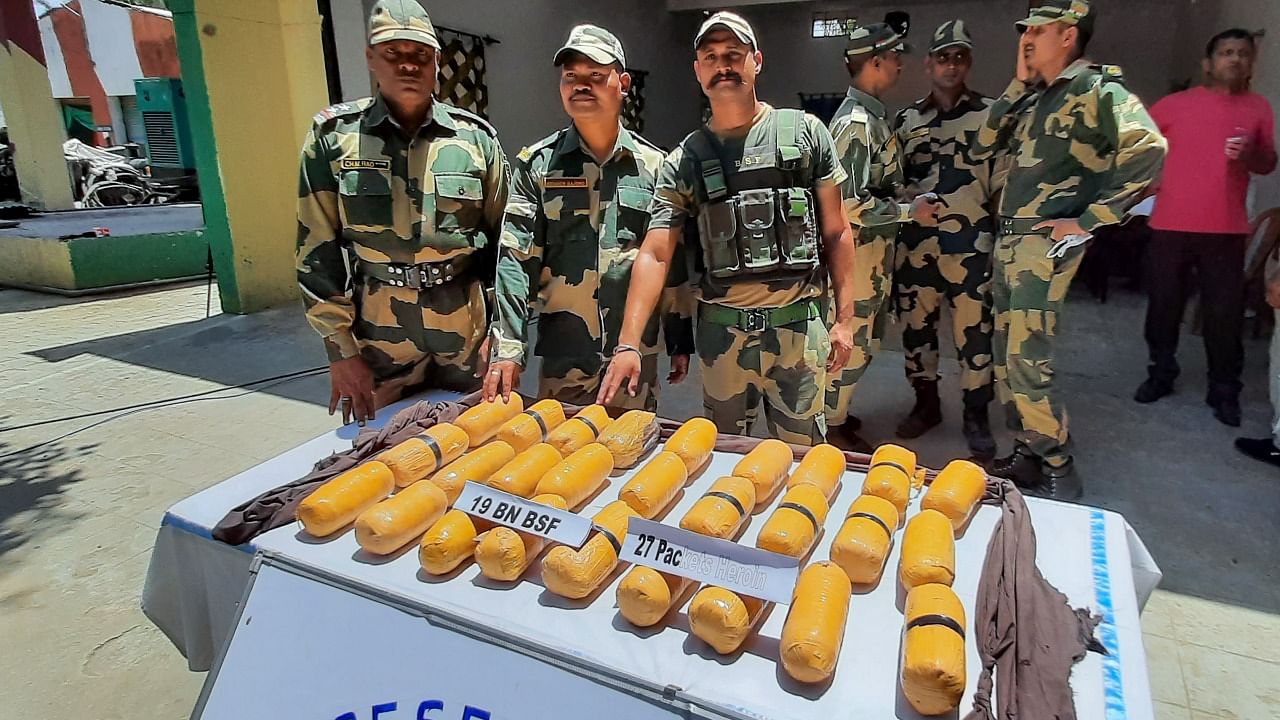 BSF personnel display heroin seized from an alleged Pakistani smuggler, after he was shoot dead along the International Border, in Kathua district, Wednesday, June 23, 2021. Credit: PTI Photo