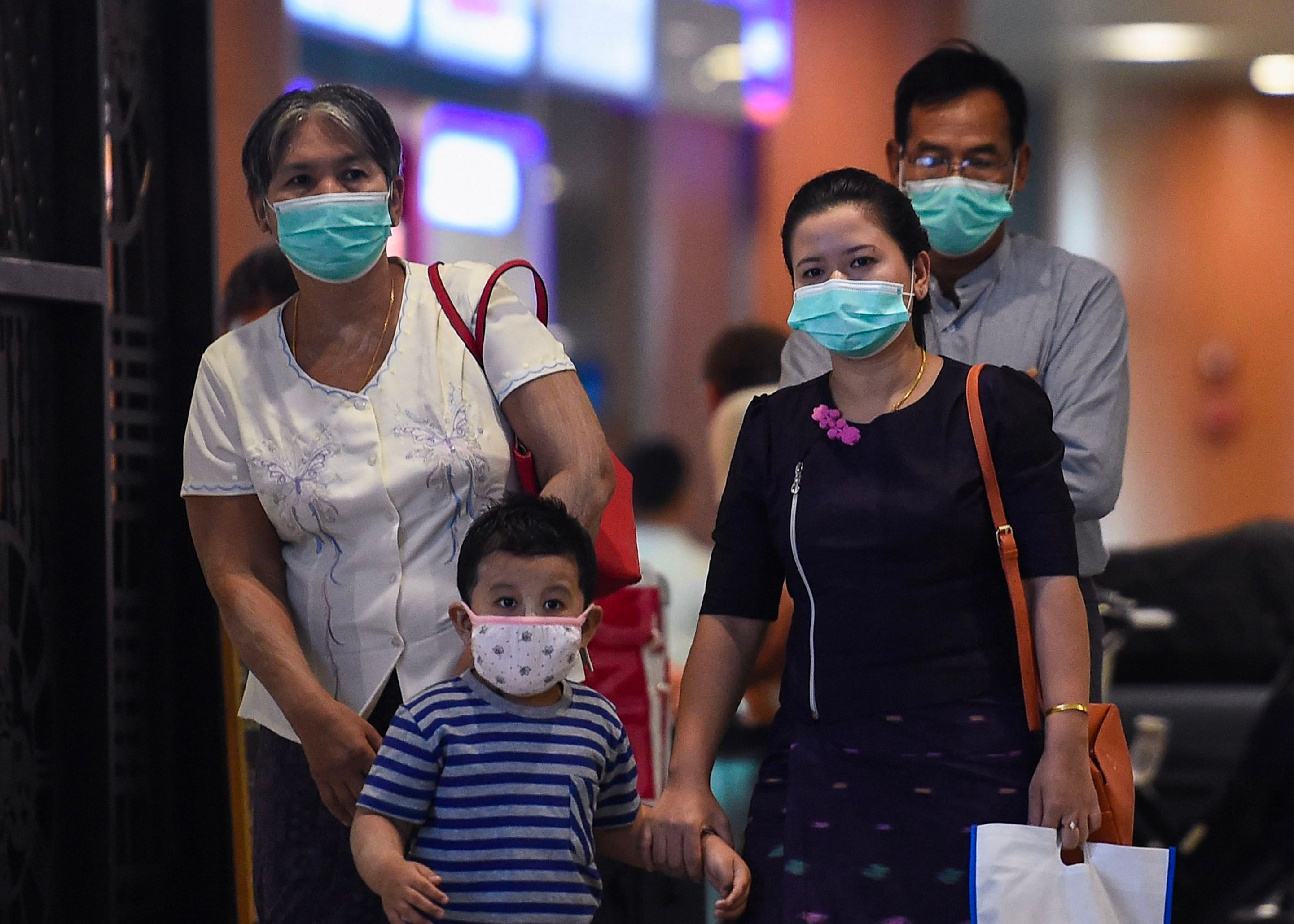 People wear protective facemasks at the Yangon international aiport in Yangon. (Photo Credits: AFP)