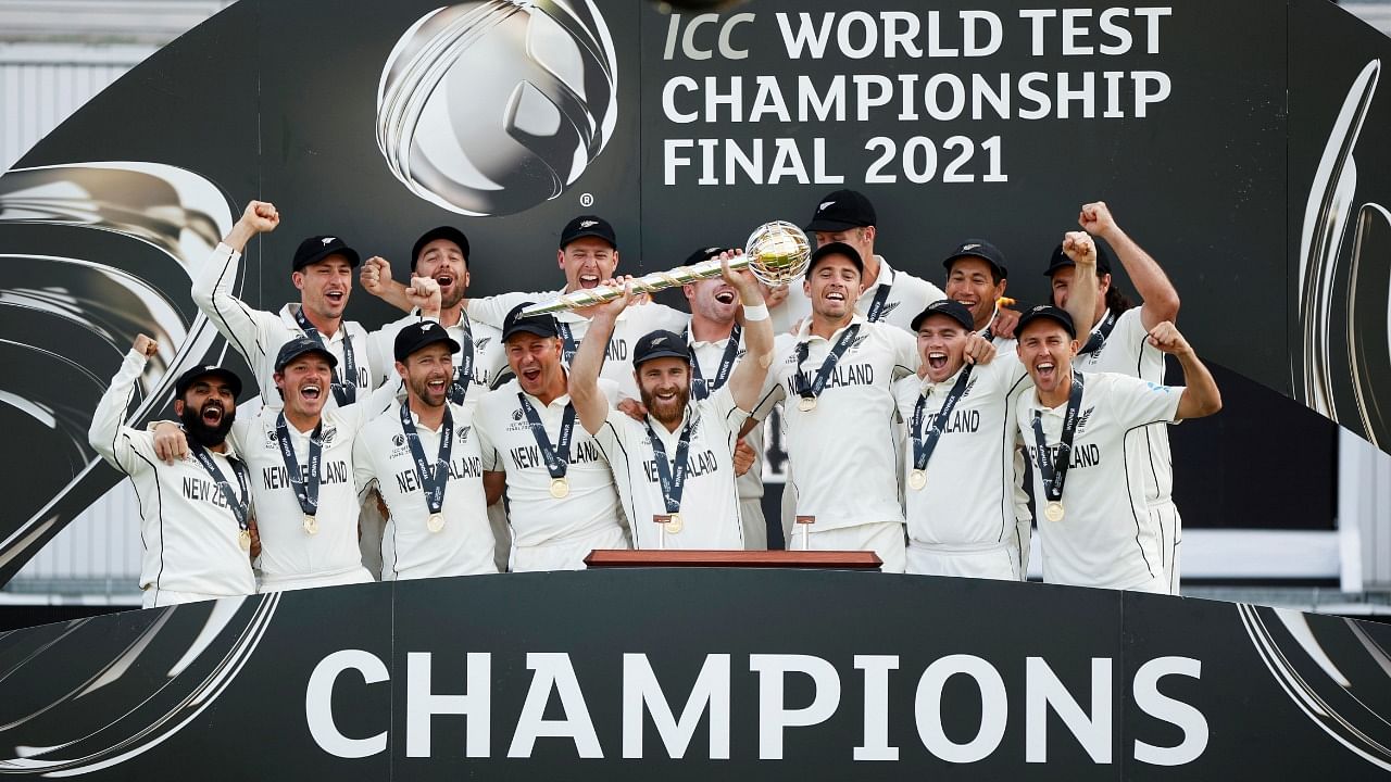 New Zealand's Kane Williamson celebrates with the trophy and teammates after winning the final to become the ICC World Test Champions. Credit: Reuters Photo
