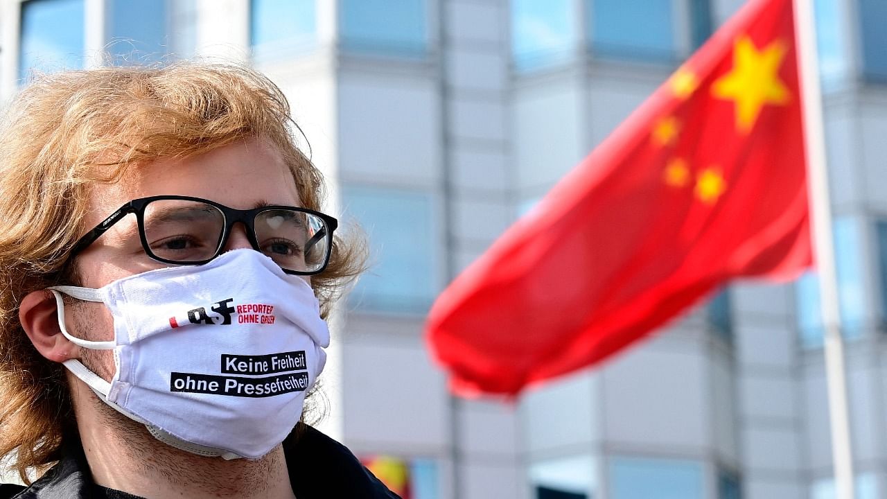 An activist of press freedom group Reporters Without Borders (Reporter sans Frontieres - RSF) attends a demonstration in front of the Chinese embassy in support of freedom of press in Hong Kong on June 25, 2021 in Berlin. Credit: AFP Photo