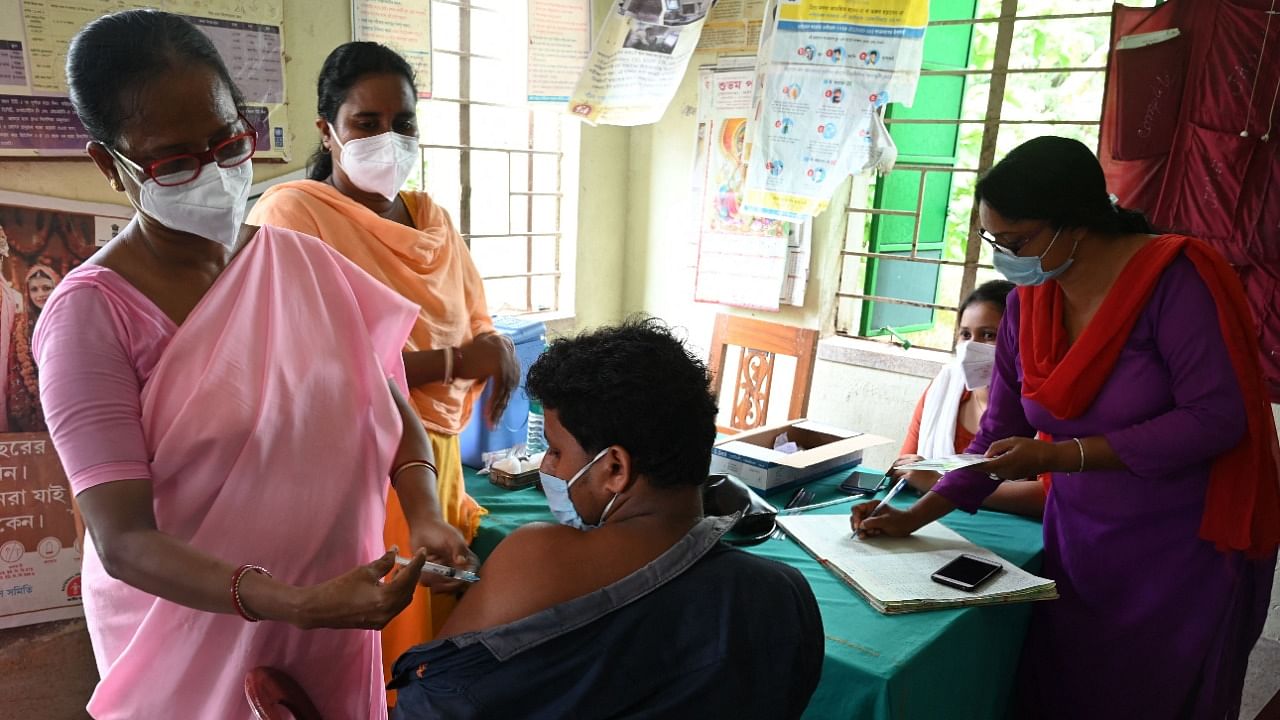 A health worker inoculates a man with a dose of the Covishield vaccine against Covid-19 coronavirus during a vaccination drive in the Sundarbans area in the south 24Parganas district, some 100 Km south of Kolkata on June 25, 2021. Credit: AFP Photo