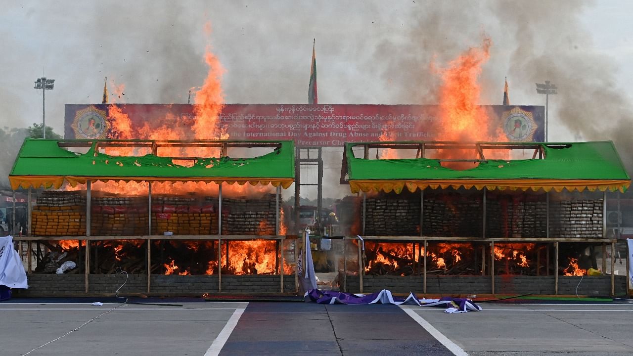 A burning pile of seized illegal drugs in Yangon. Credit: AFP Photo