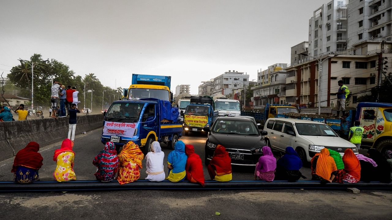 Workers from the garment sector block a road during a protest to demand payment of due wages, in Dhaka on April 15, 2020. Credit: AFP Photo