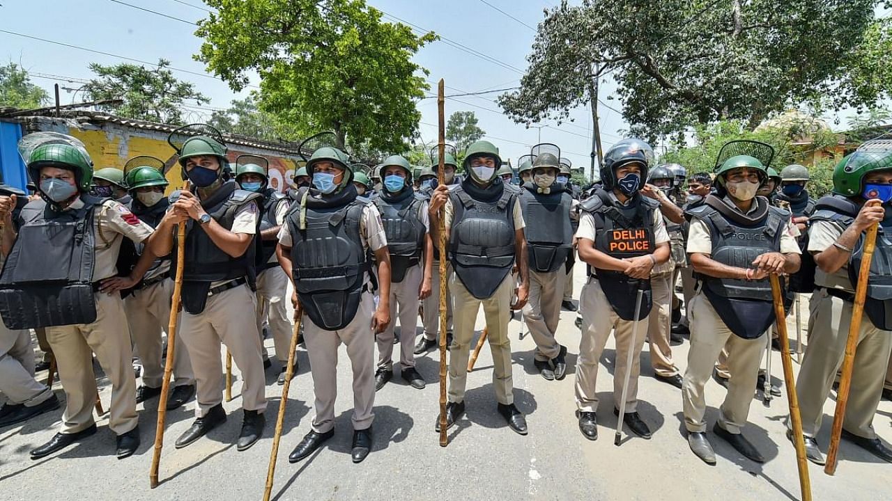 Delhi Police officials deployed near the protest site of farmers observing June 26 as 'Save Agriculture, Save Democracy' Day to mark seven months of their protest against three farm reform laws, at Singhu border in New Delhi, Saturday, June 26, 2021. Credit: PTI Photo