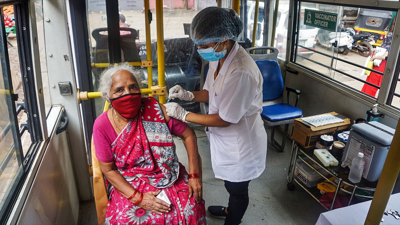 An elderly woman getting vaccinated against Covid-19 in Maharashtra. Credit: PTI Photo