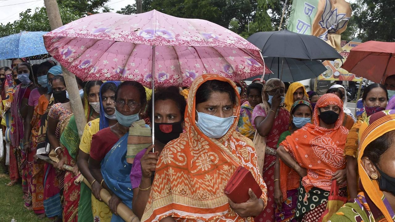 Needy people wait in queues to receive free food packages under 'Chief Minister Covid Special Relief Package Scheme', in Agartala, Friday, June 25, 2021. Credit: PTI Photo