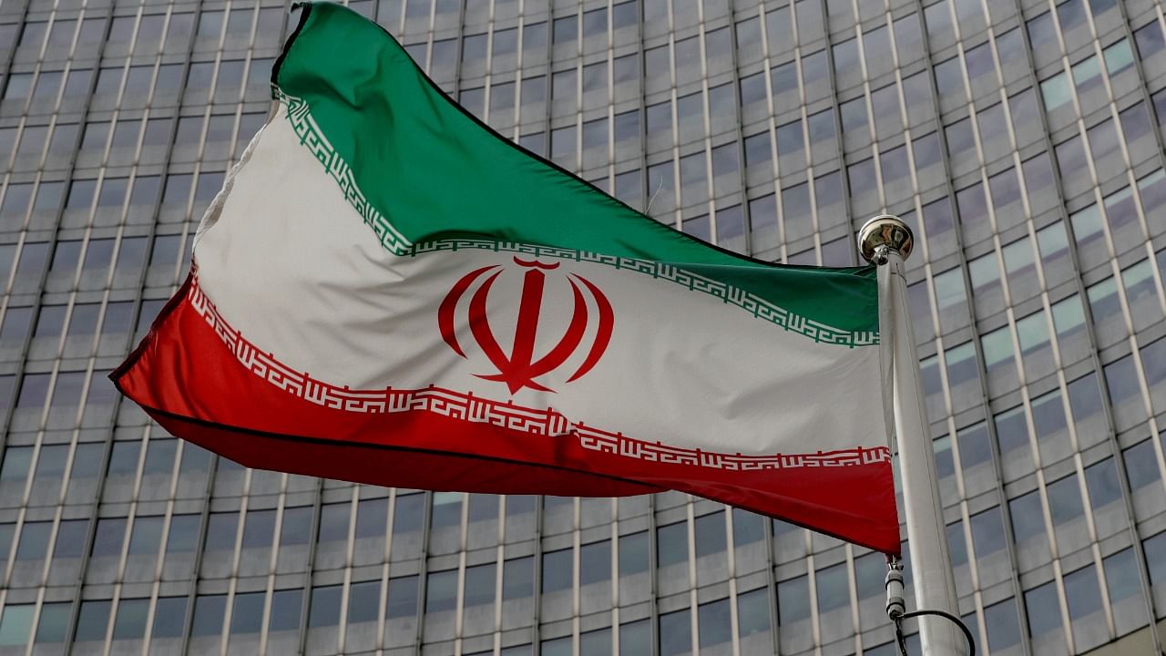 An Iranian flag flutters in front of the International Atomic Energy Agency (IAEA) headquarters in Vienna, Austria. Credit: Reuters File Photo