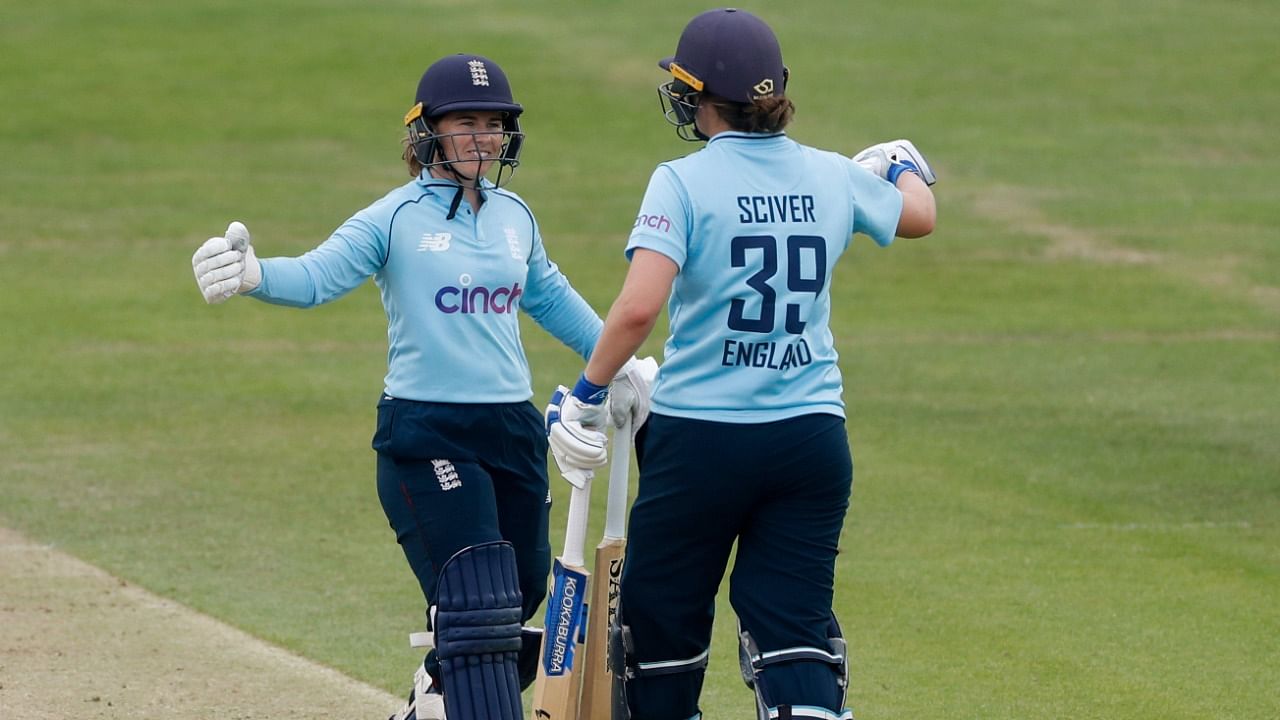 England’s Tammy Beaumont and Nat Sciver celebrate after winning the match. Credit: Reuters Photo