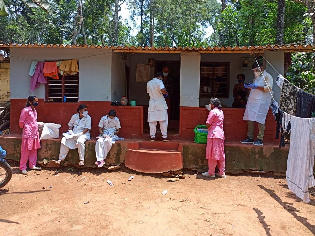 Covid warriors collect swab samples from people in a rural area in Kodagu.