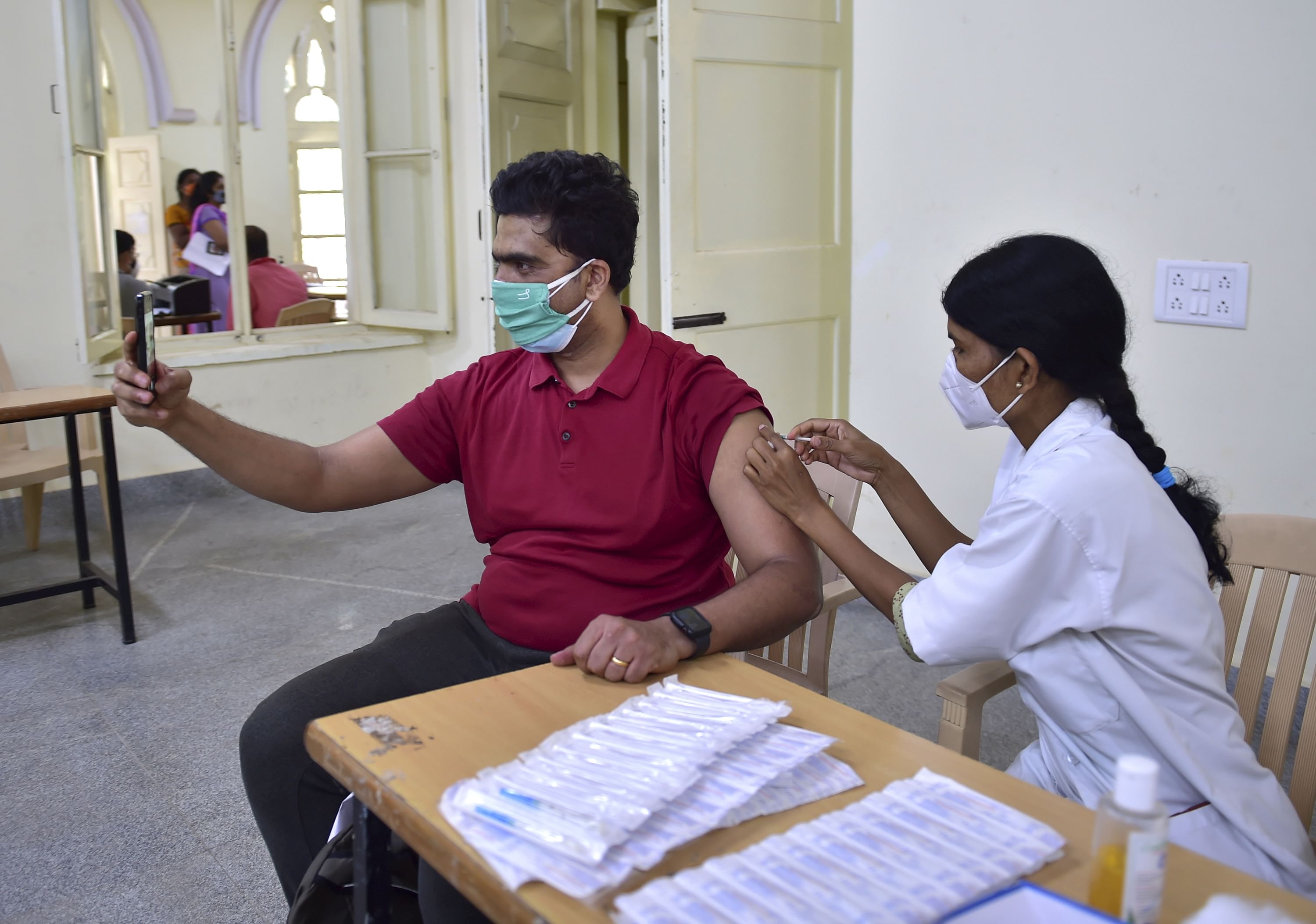 A health worker administers a dose of Covid-19 vaccine to a beneficiary in Karnataka. Credit: PTI Photo