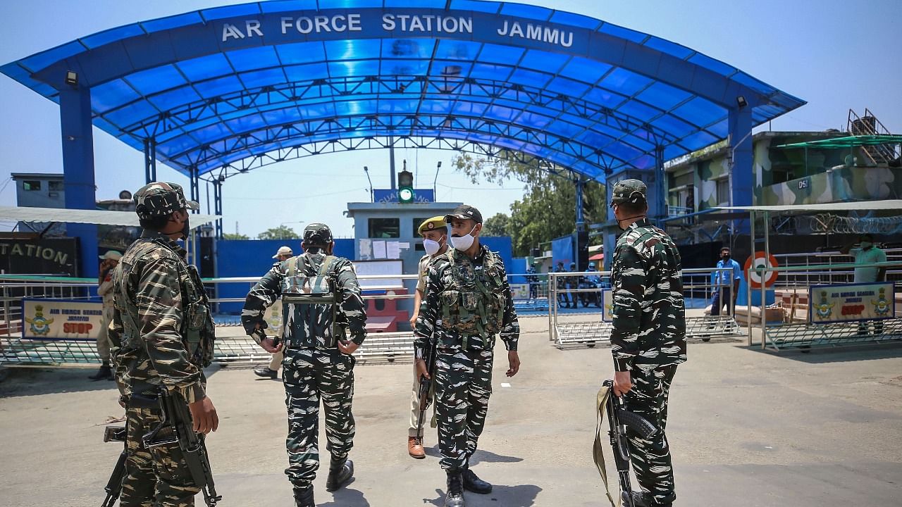 Security personnel stand guard outside Air Force Station after two low intensity explosions were reported in the technical area of Jammu Air Force Station. Credit: PTI Photo