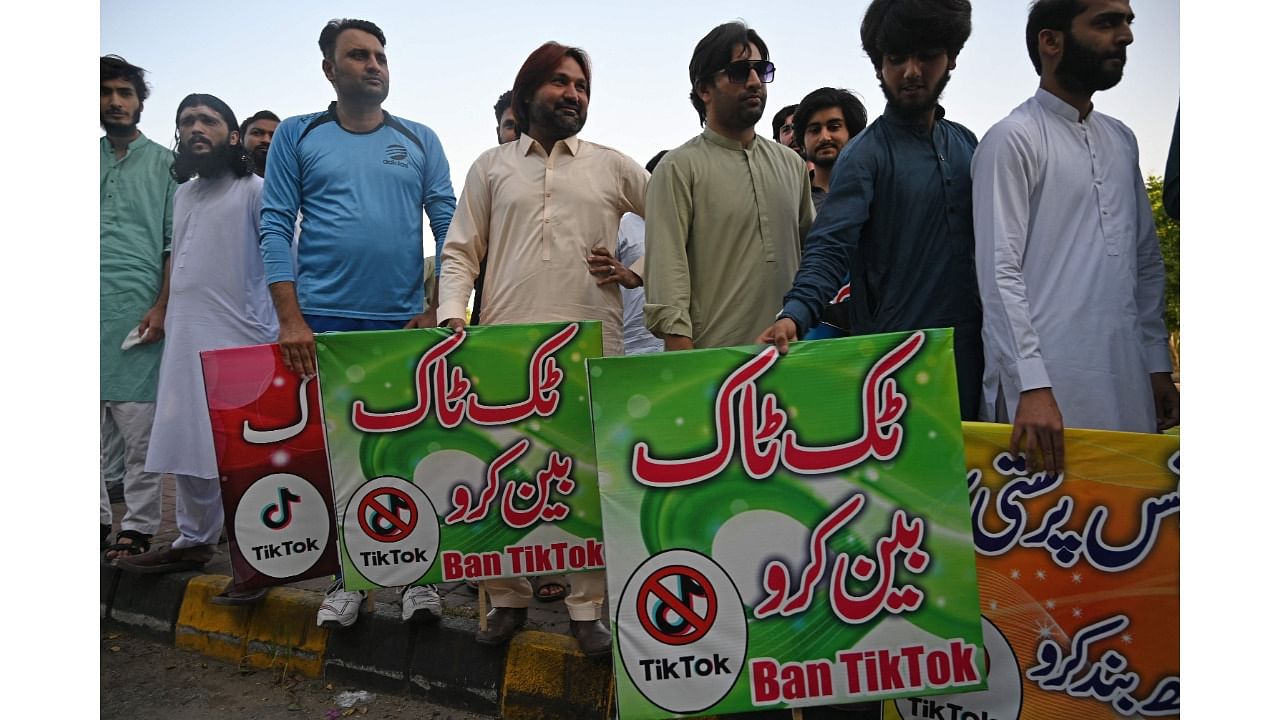 Activists carry banners and placards as they take part in a demonstration demanding the ban of a social media application 'TikTok' in Islamabad. Credit: AFP Photo