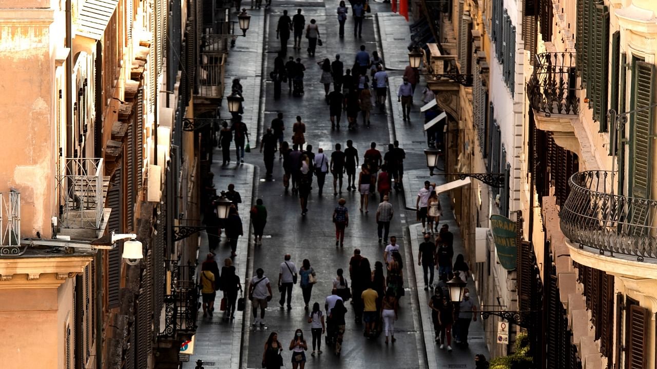 People walk along a street on the eve of Italy moving into the 'white zone'. Credit: AFP Photo
