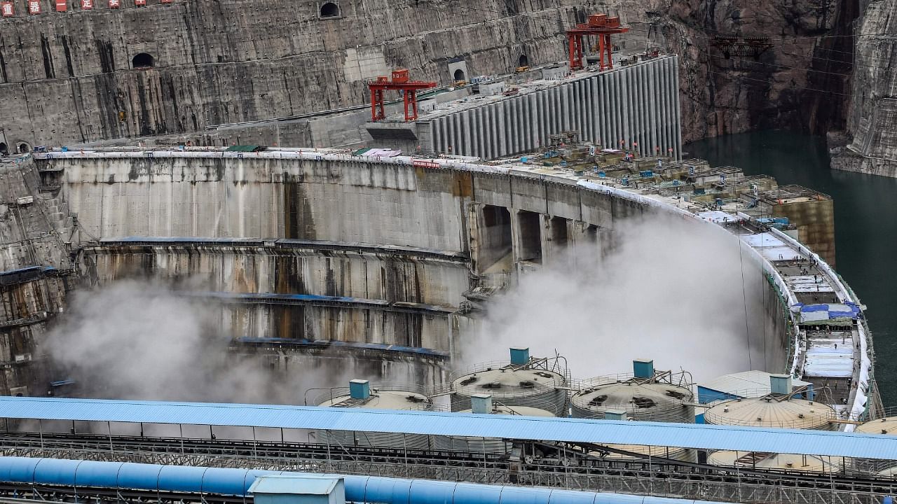 This photo taken on June 22, 2021 shows water being released from the 289-metre (948 ft.) tall Baihetan Hydropower Station, taken from the Liangshan side of the dam in China's southwestern Sichuan province. Credit: AFP photo