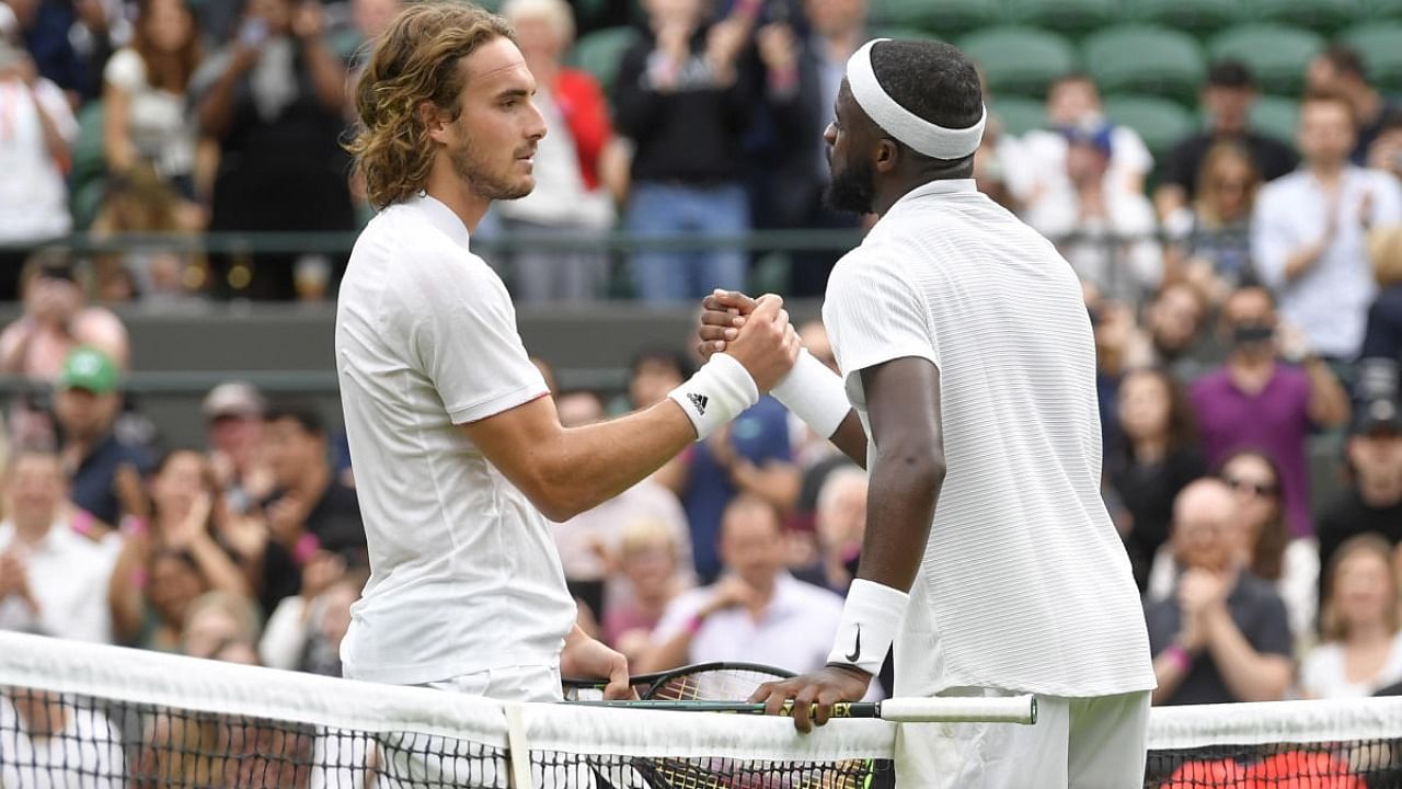 Frances Tiafoe of the US shakes hands with Greece's Stefanos Tsitsipas after winning their first round match. Credit: Reuters Photo