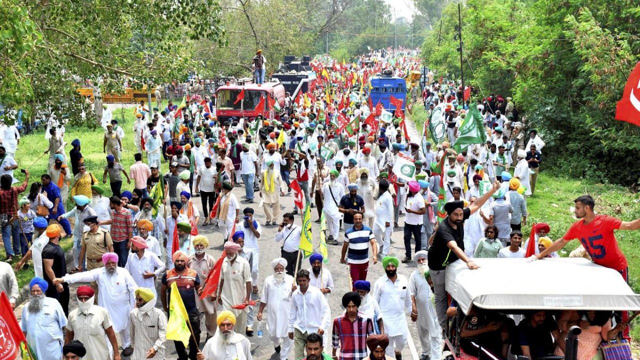 Farmers march towards Raj Bhavan to hand over a memorandum to the governor, demanding the repeal of the three farm laws, in Chandigarh. Credit: PTI Photo